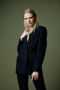 Young woman standing against blue background