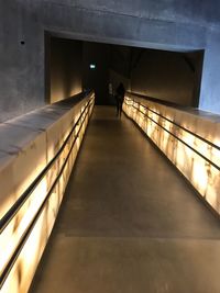 Man walking in illuminated corridor