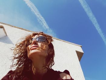 Low angle view of woman against clear sky