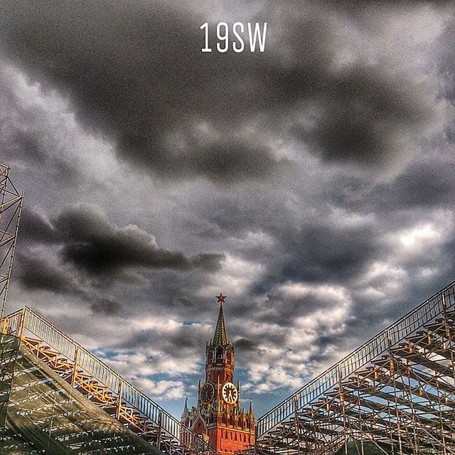 sky, cloudy, cloud - sky, low angle view, architecture, built structure, building exterior, communication, weather, overcast, religion, place of worship, travel destinations, famous place, cloud, outdoors, day, text, tower