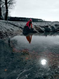 Woman by puddle