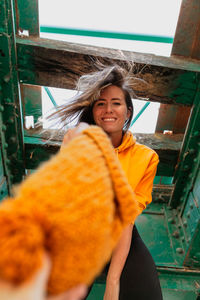 Low angle view of woman standing by railroad track