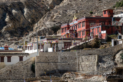 View of buildings by rock formation