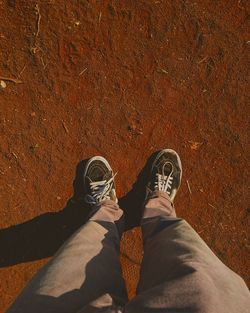 Low section of man standing on tiled floor