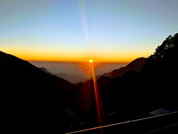Scenic view of silhouette mountains against sky during sunset