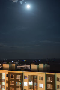 Illuminated buildings against sky at night