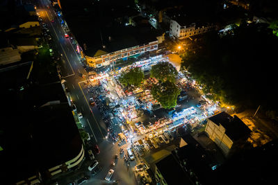 High angle view of illuminated city street and buildings at night