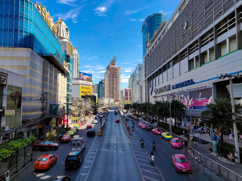 Traffic on city street amidst buildings