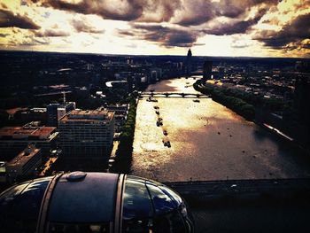 View of cityscape against cloudy sky