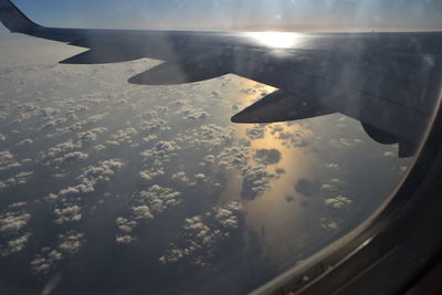 Cropped image of airplane wing over landscape