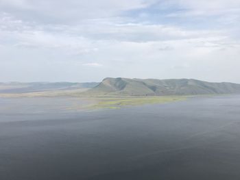 Scenic view of landscape against cloudy sky