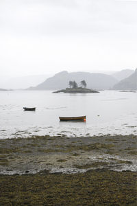 Sailboat in sea against sky