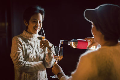 Side view of woman drinking glass