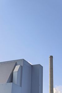 Low angle view of factory against clear sky