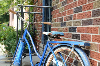 Bicycles on bicycle against brick wall