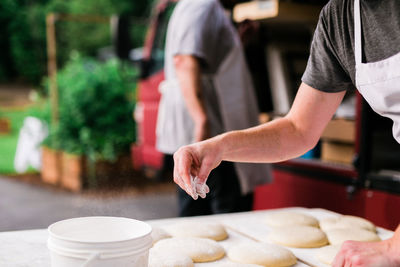 Midsection of person preparing food on table