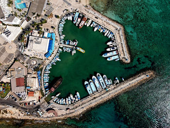 Aerial view of boat moored at sea by town