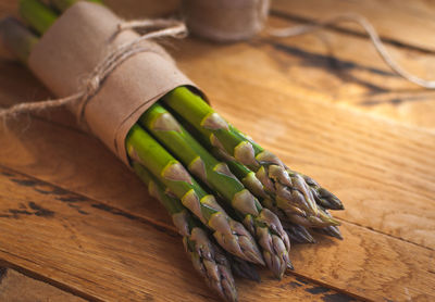 Close-up of fresh green asparagus on wooden background