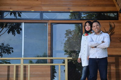 Portrait of a smiling young couple standing outdoors