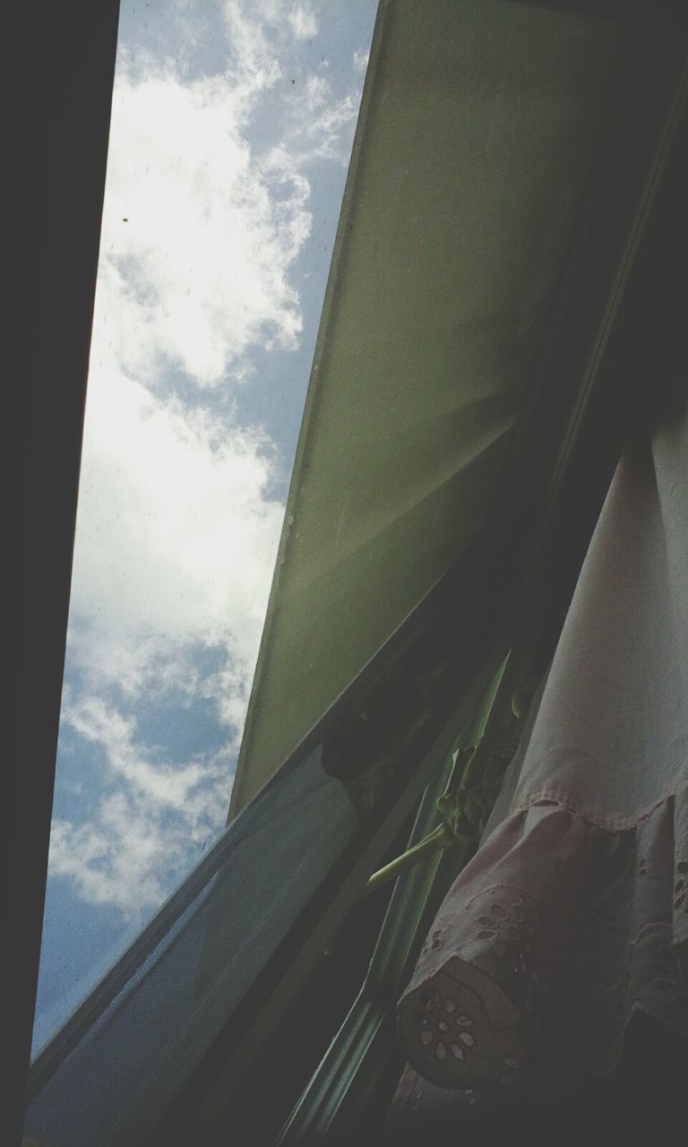 low angle view, sky, architecture, built structure, building exterior, window, cloud, cloud - sky, sunlight, day, cropped, part of, glass - material, house, building, balcony, no people, indoors, residential structure