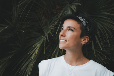 Portrait of a smiling young woman looking away