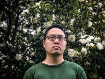 Portrait of mature man against plants and trees