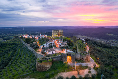 High angle view of buildings in city during sunset