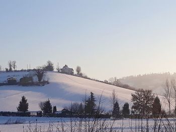 Scenic view of snow covered field against sky