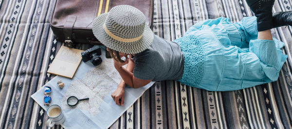 High angle view of woman looking at map