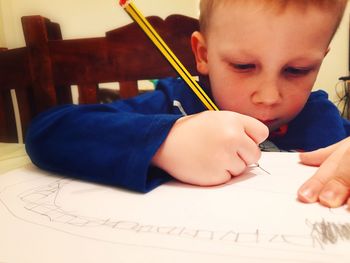 Close-up of boy drawing on paper