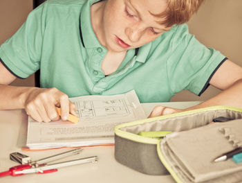 Full length of a boy sitting on table