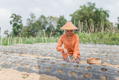 Rear view of woman standing on beach