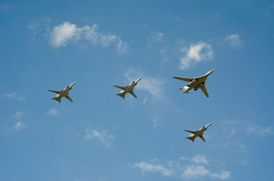 Low angle view of planes flying in sky