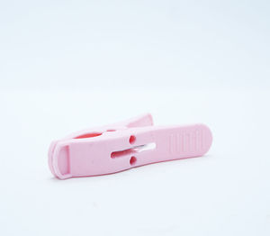 Close-up of pink toy over white background