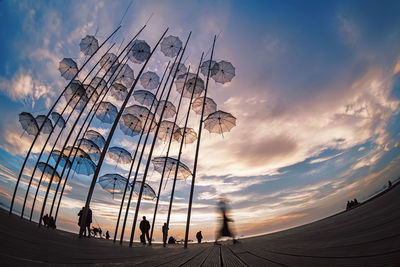 Low angle view of people enjoying at sunset