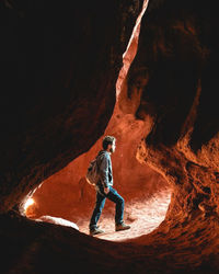 Rear view of man standing on rock formations