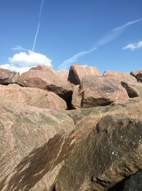 Rocks on mountain against blue sky