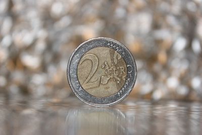 Close-up of two euro coin on table