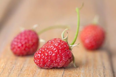 Fresh raspberries on wooden surface with shallow depth of field