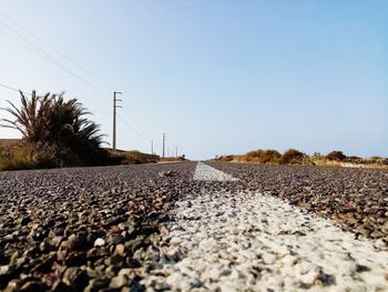 Surface level of road against clear sky