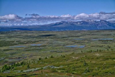 Scenic view of landscape against cloudy sky