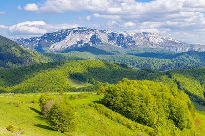 Scenic view of landscape and mountains against sky
