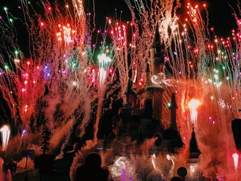 Low angle view of firework display against sky at night