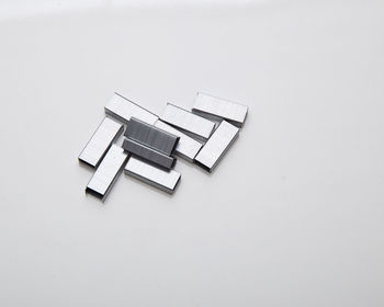 High angle view of straight pin on white background