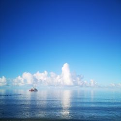 Scenic view of sea against blue sky
