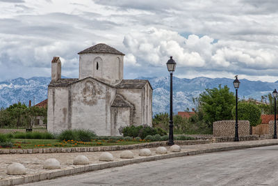 Chapel against cloudy sky