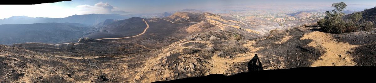 Panoramic view of landscape with mountain range in background