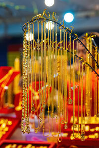 Gold necklace accessories hanging for sale at the market.