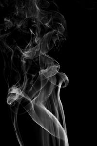 Close-up of smoke against black background