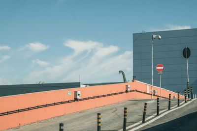 Road by building against sky